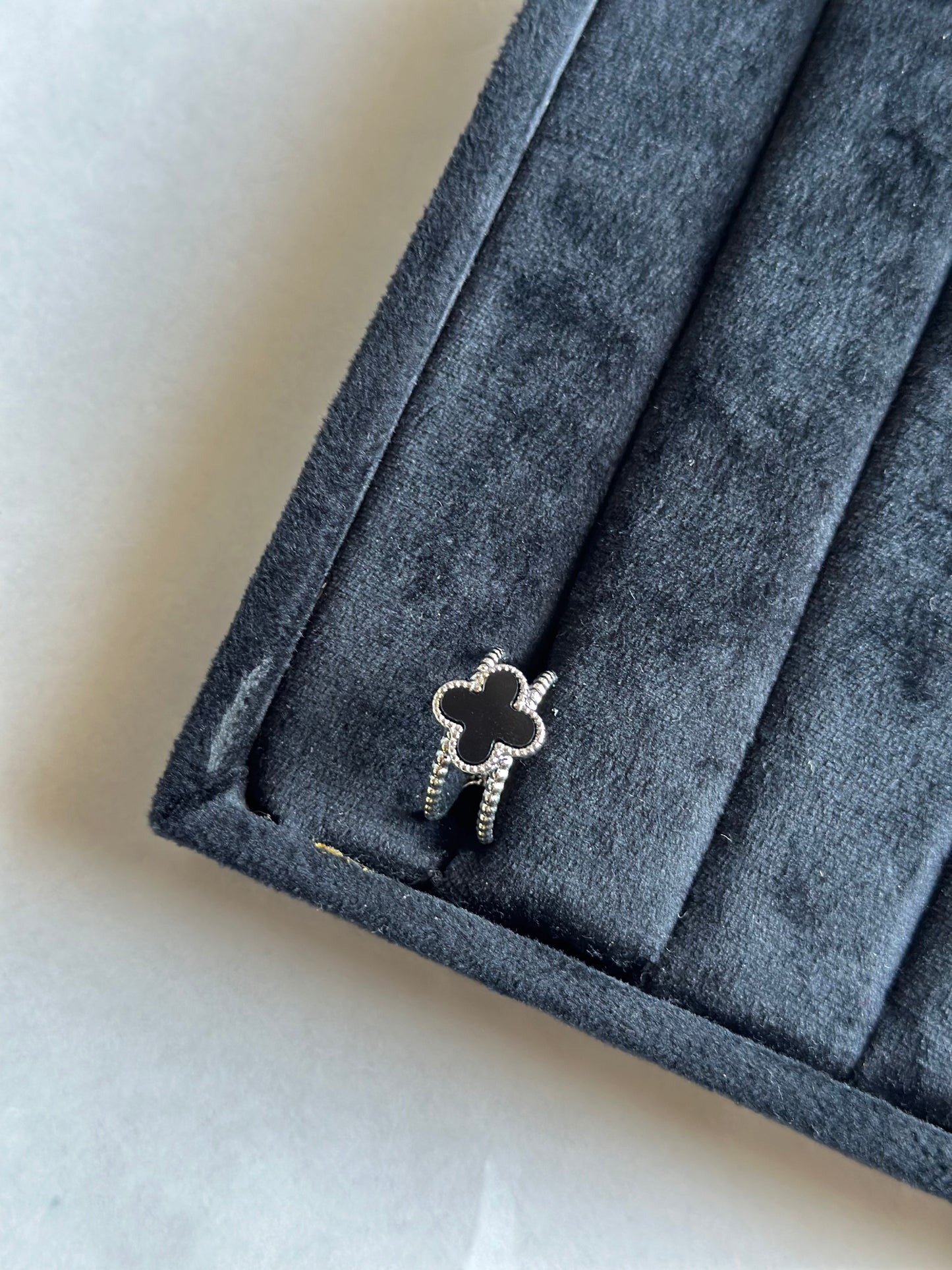 Silver colored vancleef ring