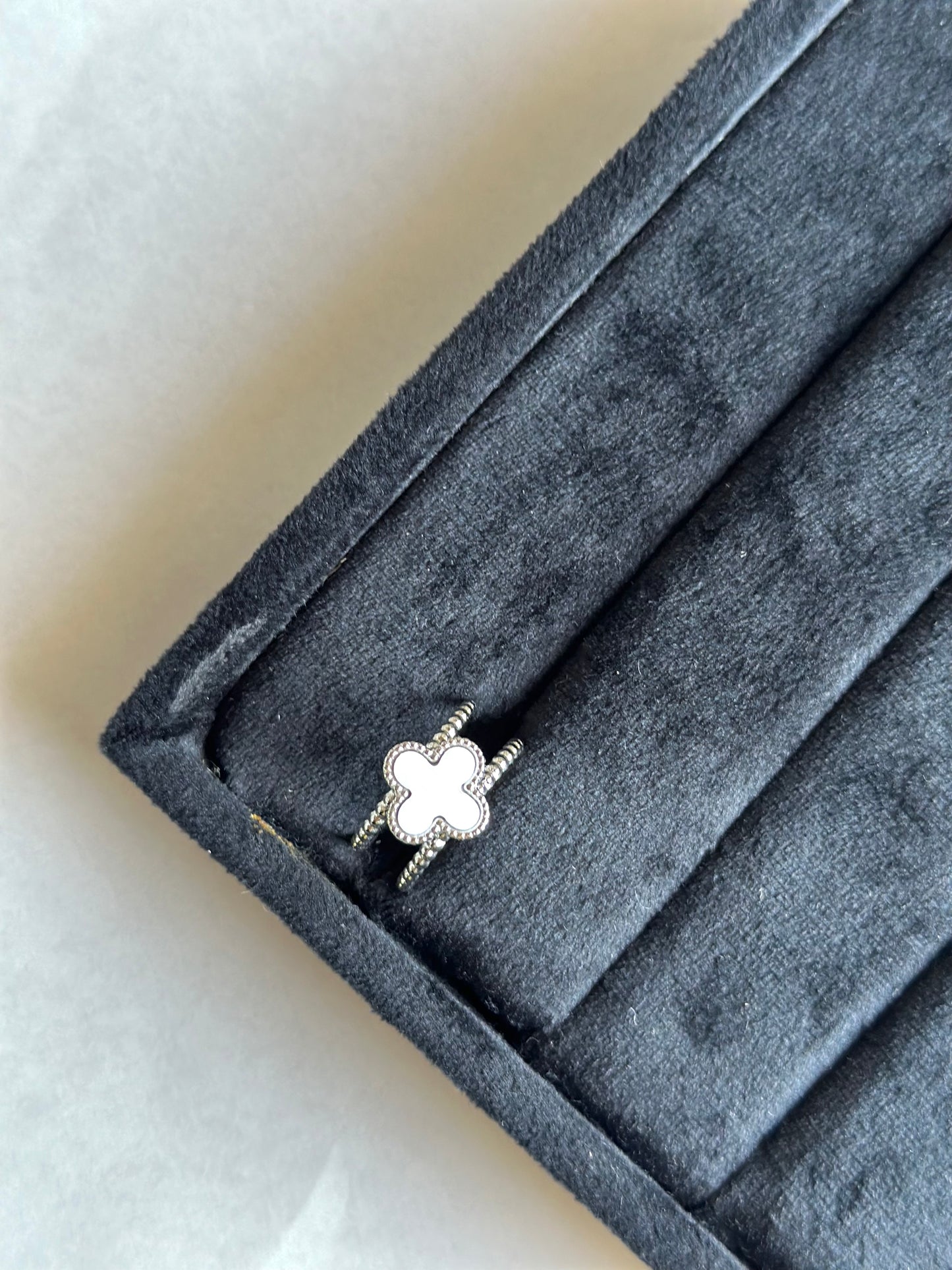 Silver colored vancleef ring